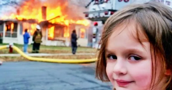 Child smirking as house in on fire in the background
