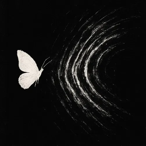 A white butterfly with waves rippling away from it